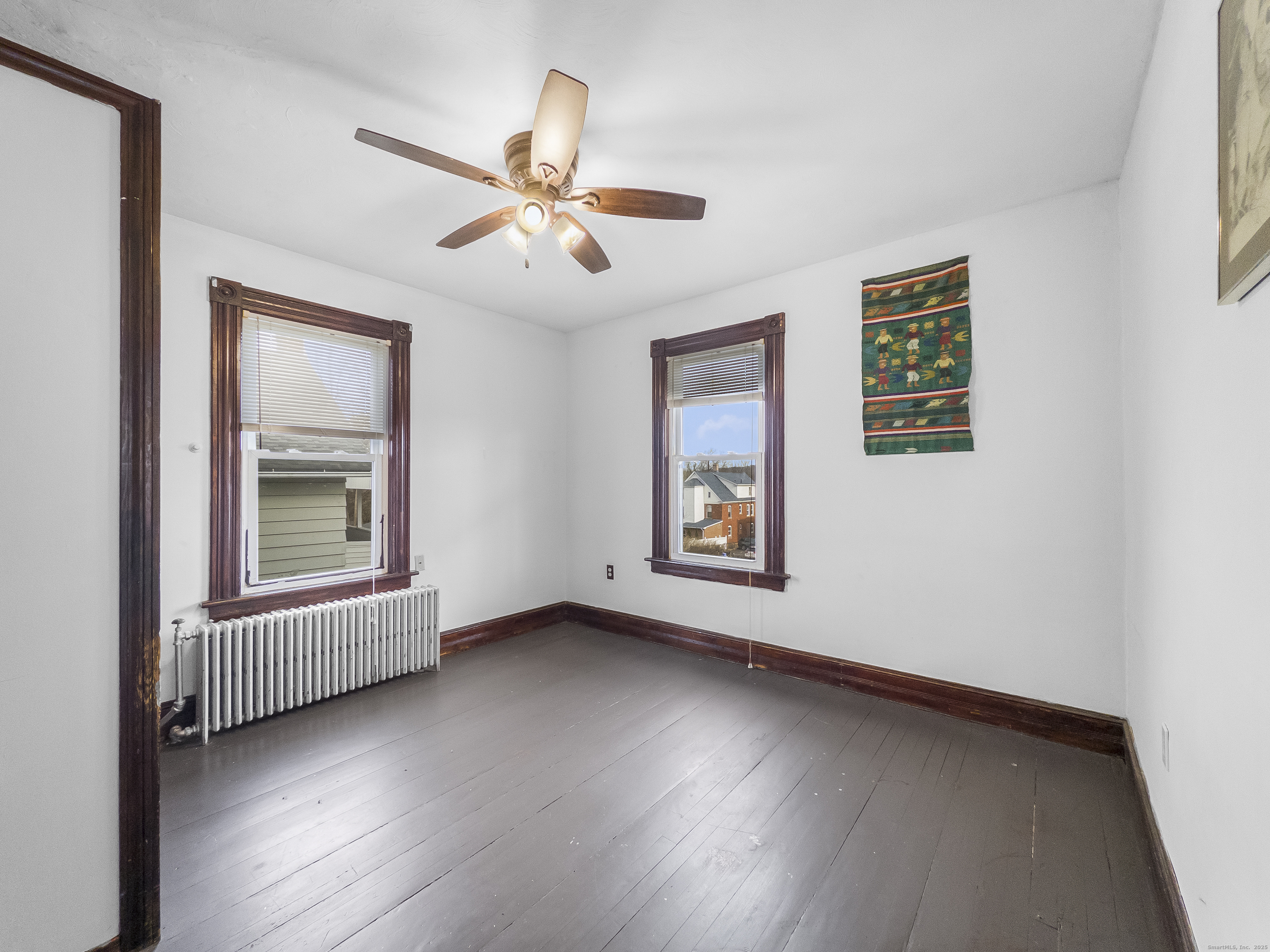 634 High Street, Unit 2 Middletown, CT 06457 - Photo 13 of 15 a view of an empty room with a window and wooden floor