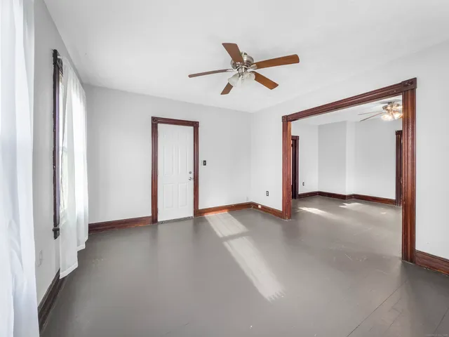 a view of a livingroom with a ceiling fan and window