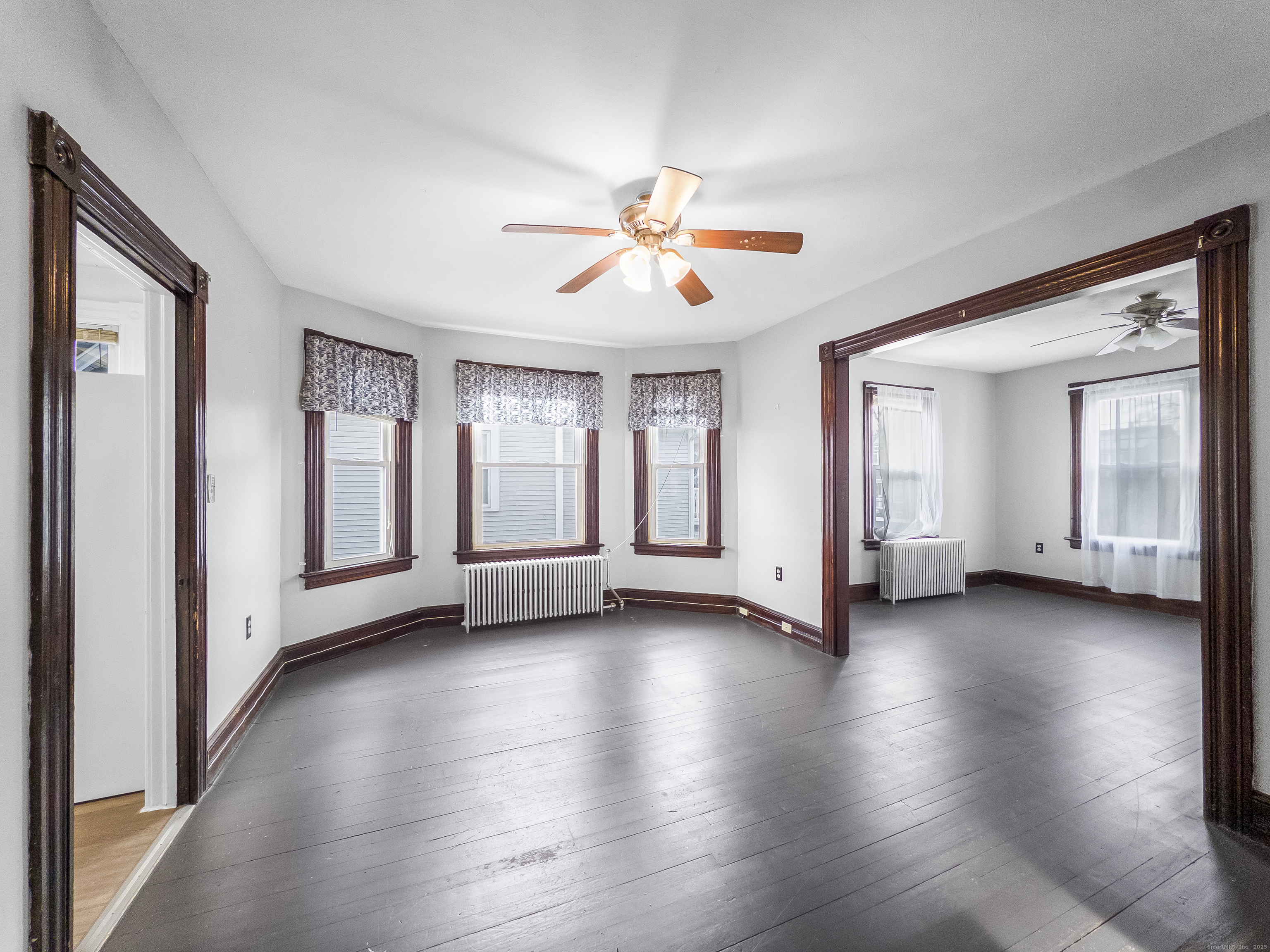 634 High Street, Unit 2 Middletown, CT 06457 - Photo 5 of 15 a view of an empty room with window and wooden floor