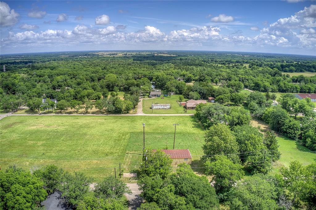 414 North Neal Street Commerce, TX 75428 - Photo 9 of 13 a view of a garden with a building in the background