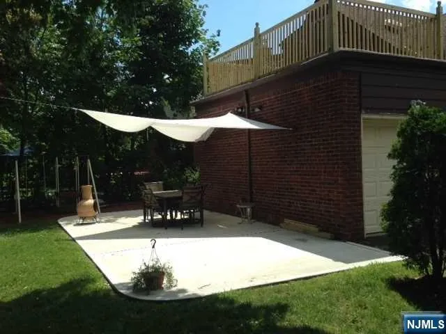 a view of a bench in patio with a yard