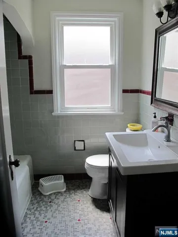 a bathroom with a sink toilet and mirror