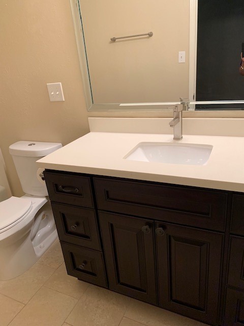 407 West Semands Street Conroe, TX 77301 - Photo 17 of 28 a bathroom with a sink a toilet and mirror