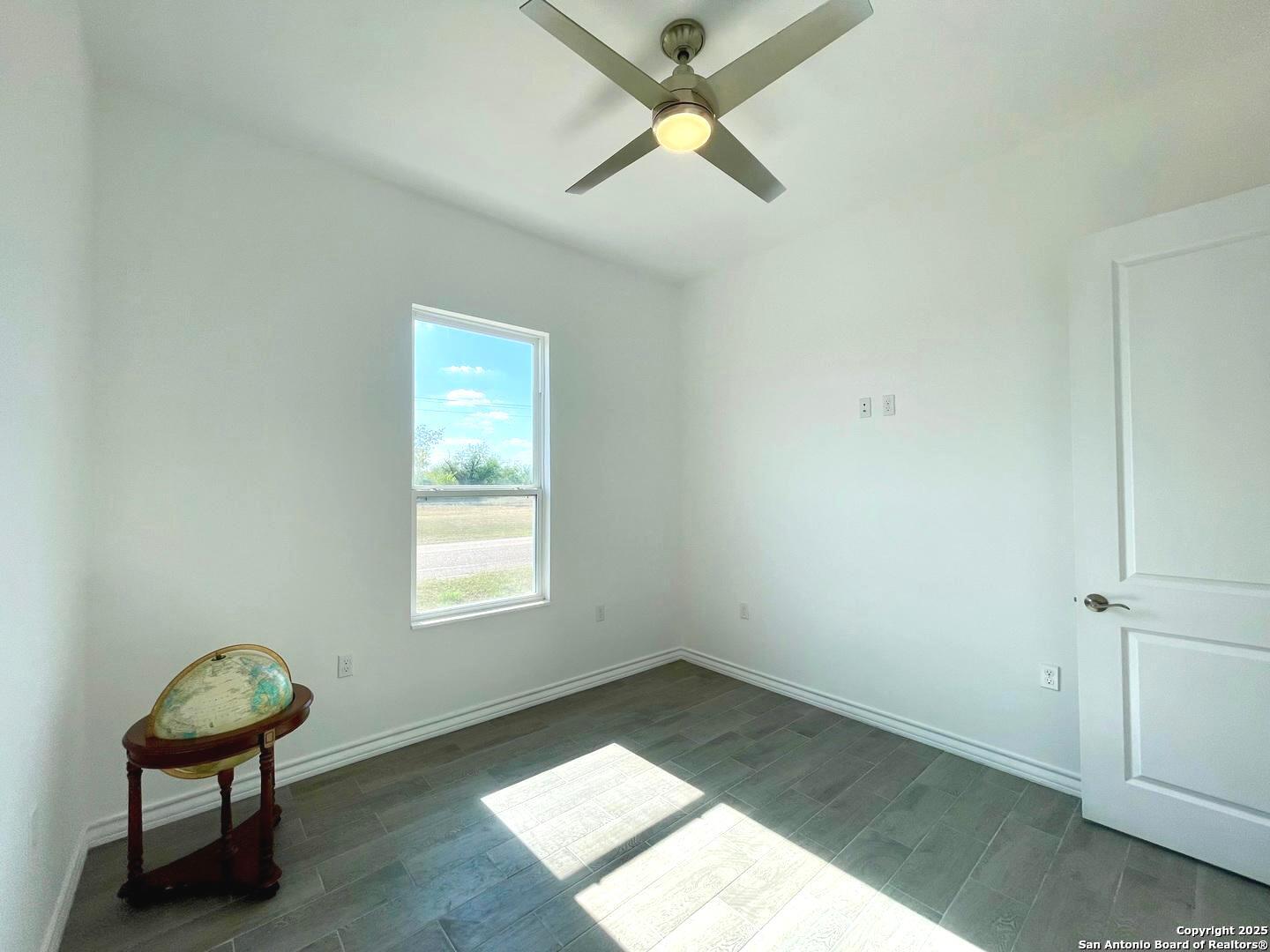 97 Berwick Road Victoria, TX 77904 - Photo 13 of 35 an empty room with a window and a fan