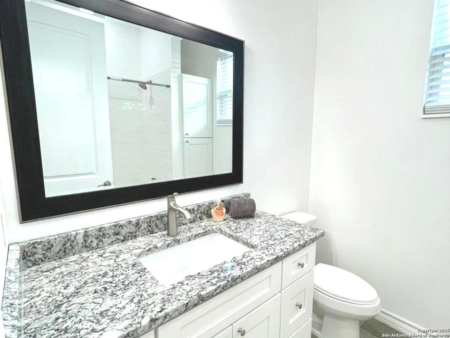 97 Berwick Road Victoria, TX 77904 - Photo 16 of 35 a bathroom with a granite countertop sink and a mirror