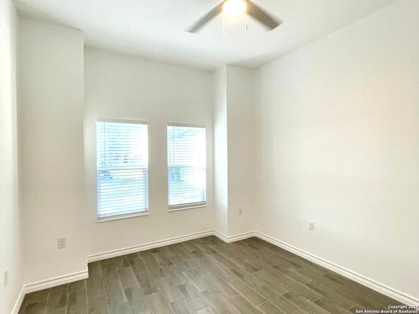 97 Berwick Road Victoria, TX 77904 - Photo 18 of 35 an empty room with wooden floor and windows