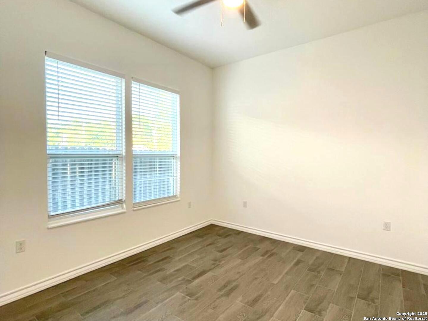 97 Berwick Road Victoria, TX 77904 - Photo 19 of 35 an empty room with wooden floor and windows