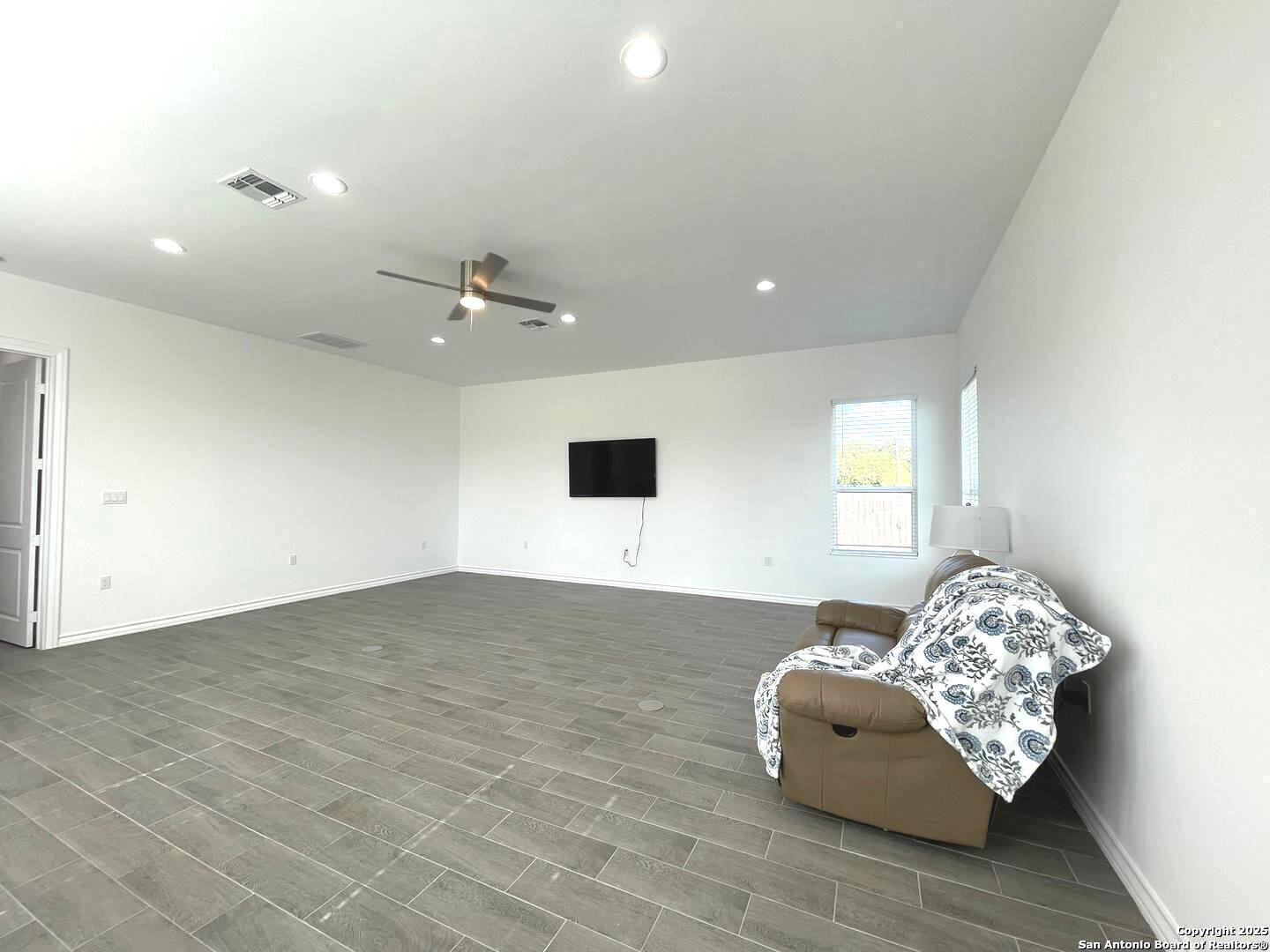 97 Berwick Road Victoria, TX 77904 - Photo 22 of 35 a living room with furniture and a floor to ceiling window
