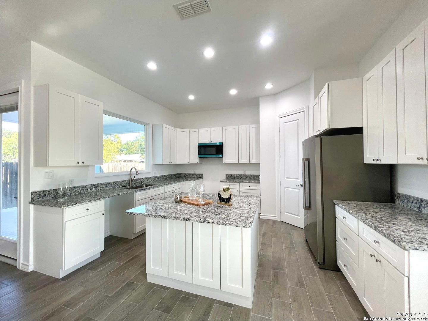 97 Berwick Road Victoria, TX 77904 - Photo 7 of 35 a kitchen with stainless steel appliances granite countertop a sink stove refrigerator and cabinets