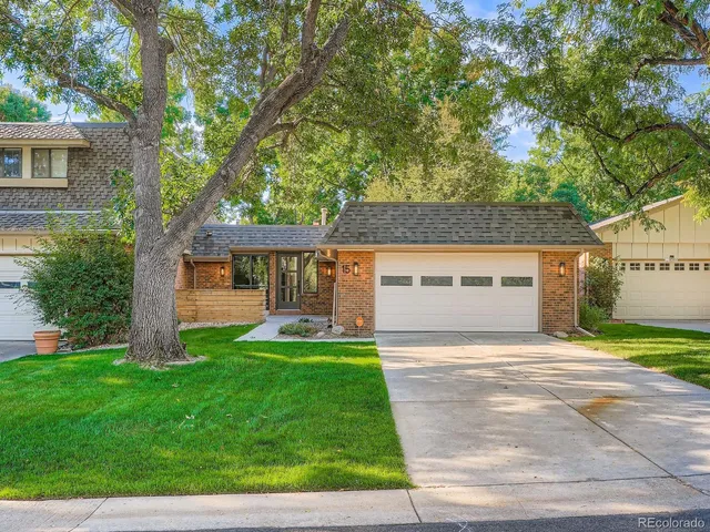 a front view of a house with a yard and a patio