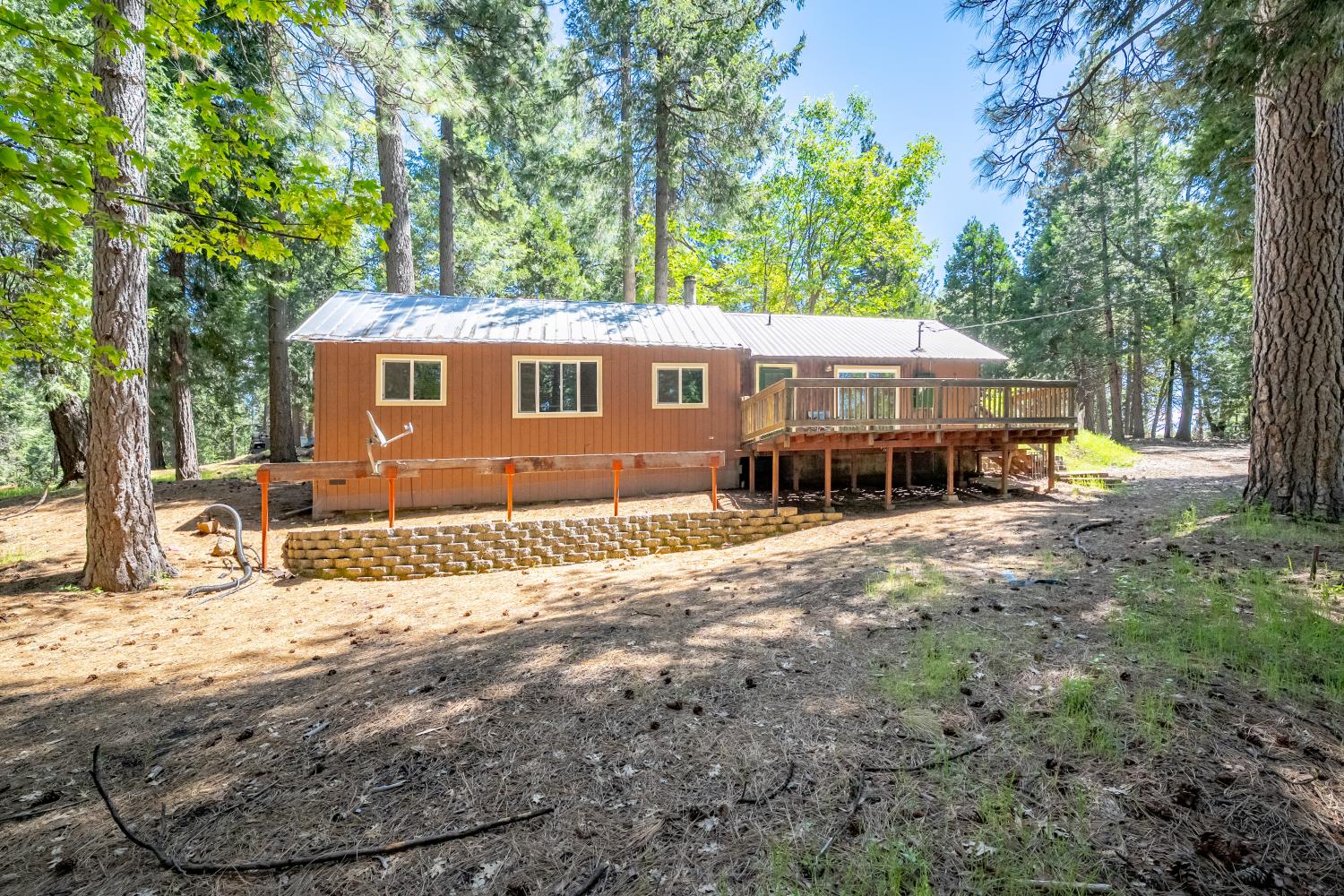 6420 Starkes Grade Road Pollock Pines, CA 95726 - Photo 20 of 58 a backyard of a house with table and chairs under an umbrella