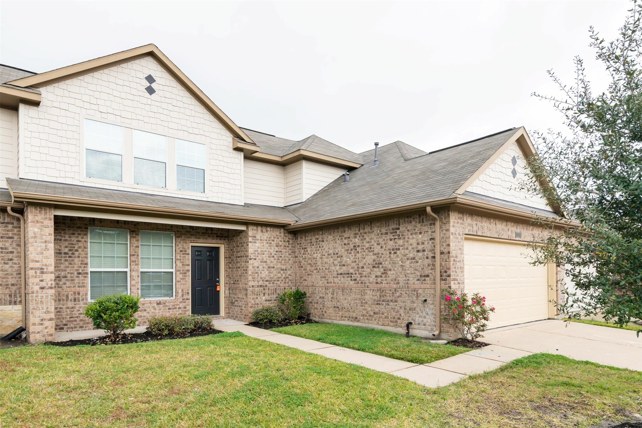 12311 Dona Lane Houston, TX 77044 - Photo 15 of 16 a front view of a house with a yard and garage