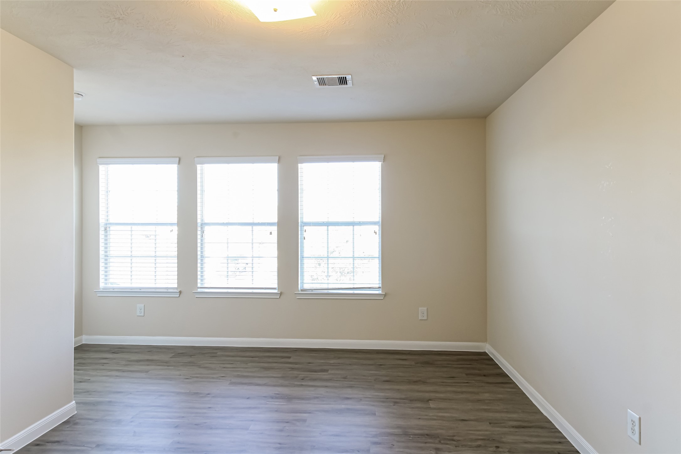 12311 Dona Lane Houston, TX 77044 - Photo 5 of 16 an empty room with wooden floor and windows