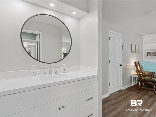 4650 Wiggins Lane Wilmer, AL 36587 - Photo 18 of 66 Bathroom with dark wood finished floors, vanity, and recessed lighting