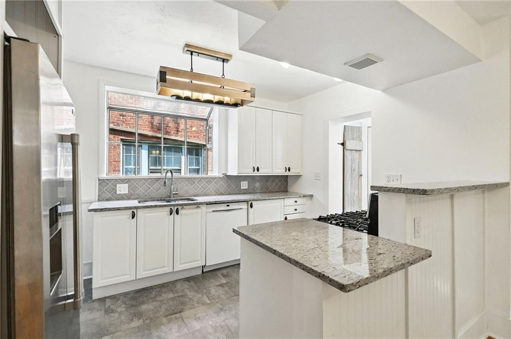 5248 Beelermont Place Pittsburgh, PA 15217 - Photo 12 of 36 a kitchen with a sink a center island and cabinets