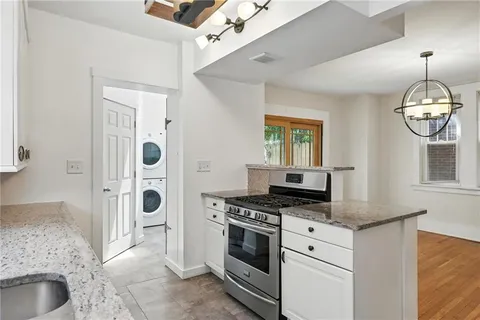 a kitchen with a stove a sink and a refrigerator