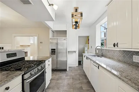 a large kitchen with a stove and a sink