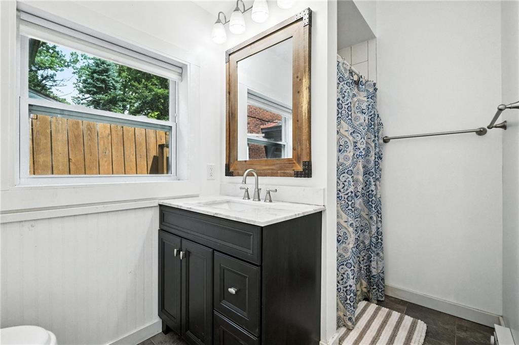 5248 Beelermont Place Pittsburgh, PA 15217 - Photo 18 of 36 a bathroom with a sink and a mirror
