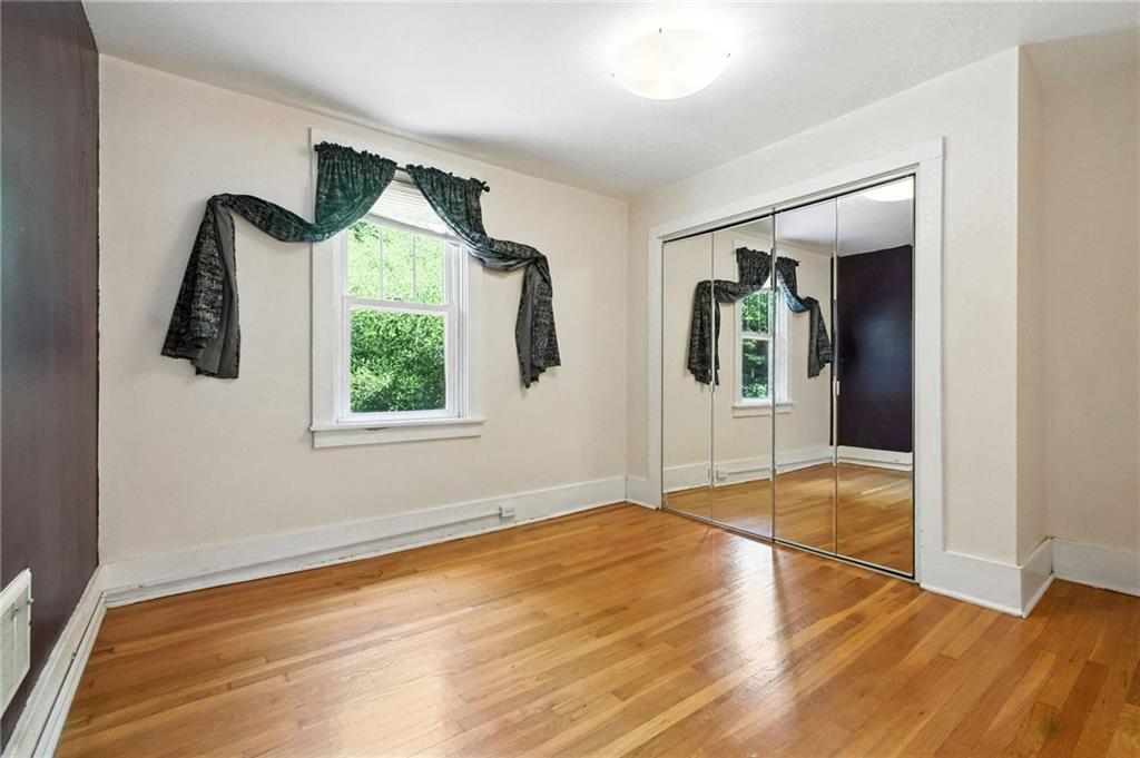 5248 Beelermont Place Pittsburgh, PA 15217 - Photo 22 of 36 a view of an empty room with wooden floor and a window