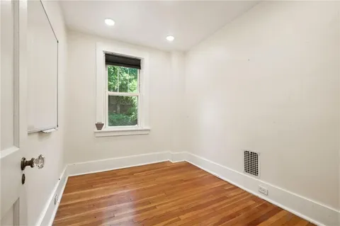a bathroom with a tub a sink and mirror