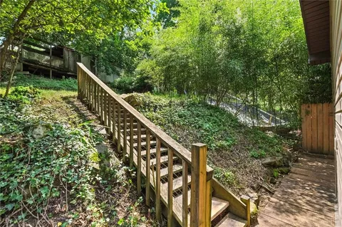 a backyard of a house with lots of green space and fountain