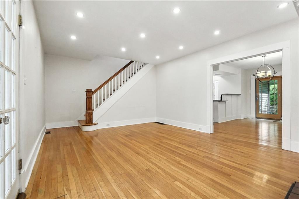 5248 Beelermont Place Pittsburgh, PA 15217 - Photo 5 of 36 a view of an empty room with wooden floor and a bathroom
