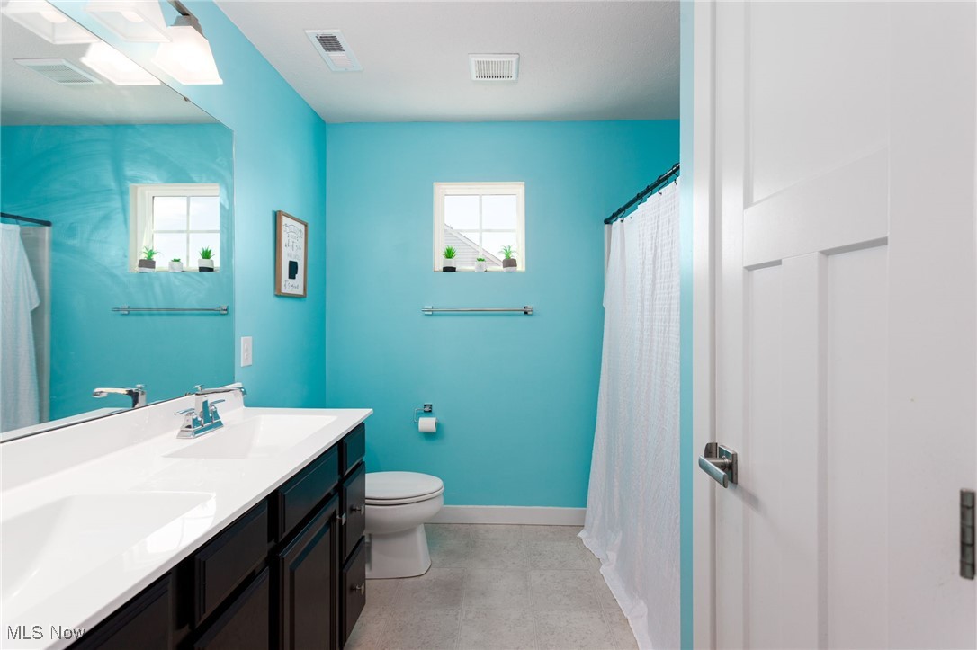 528 Oliver Way Rittman, OH 44270 - Photo 25 of 32 Owner's ensuite bathroom featuring a toilet, baseboards, sink and shower.