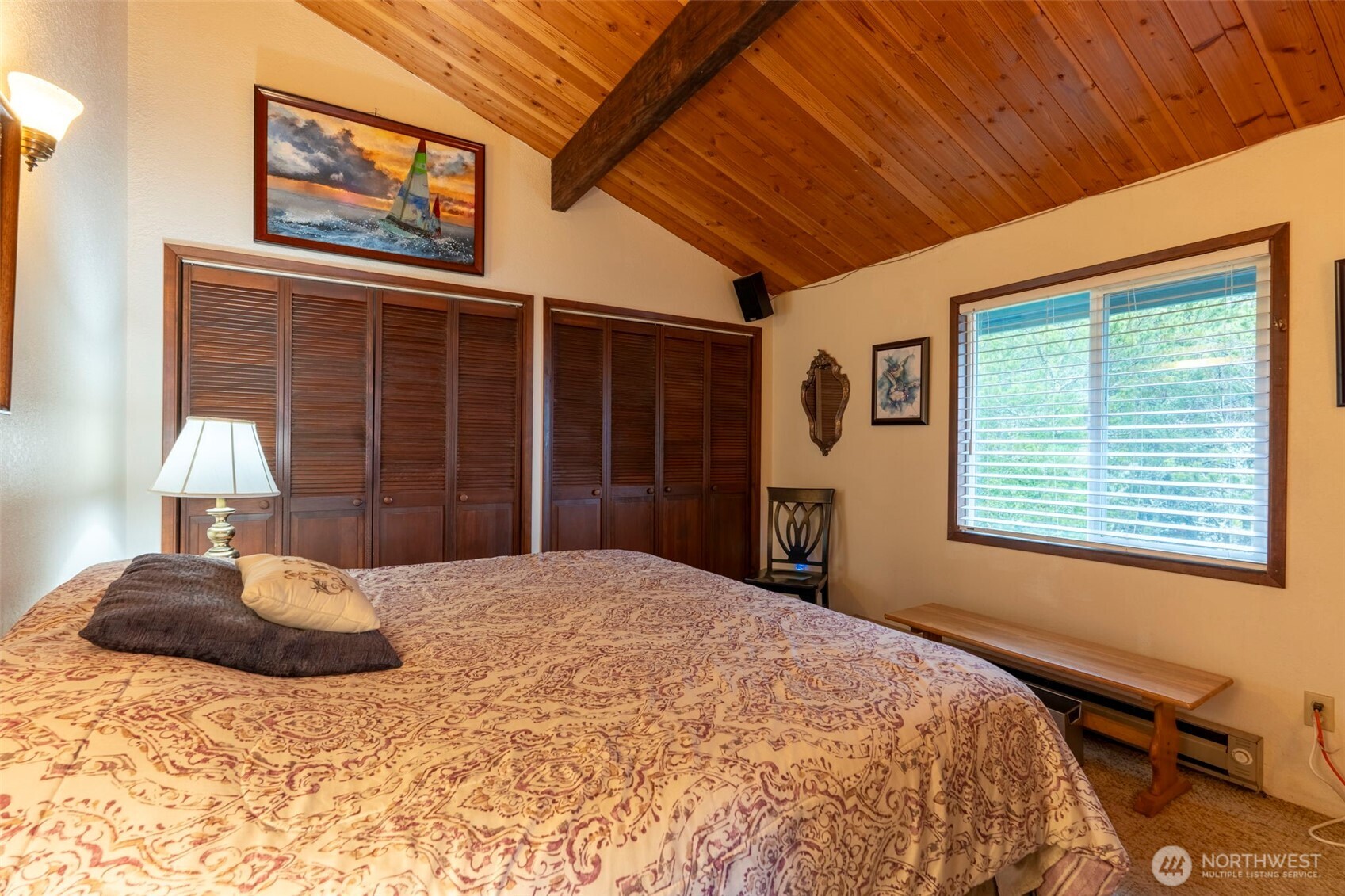326 Harbor View Loop Southeast Ocean Shores, WA 98569 - Photo 14 of 38 a bedroom with a large bed dresser and a window