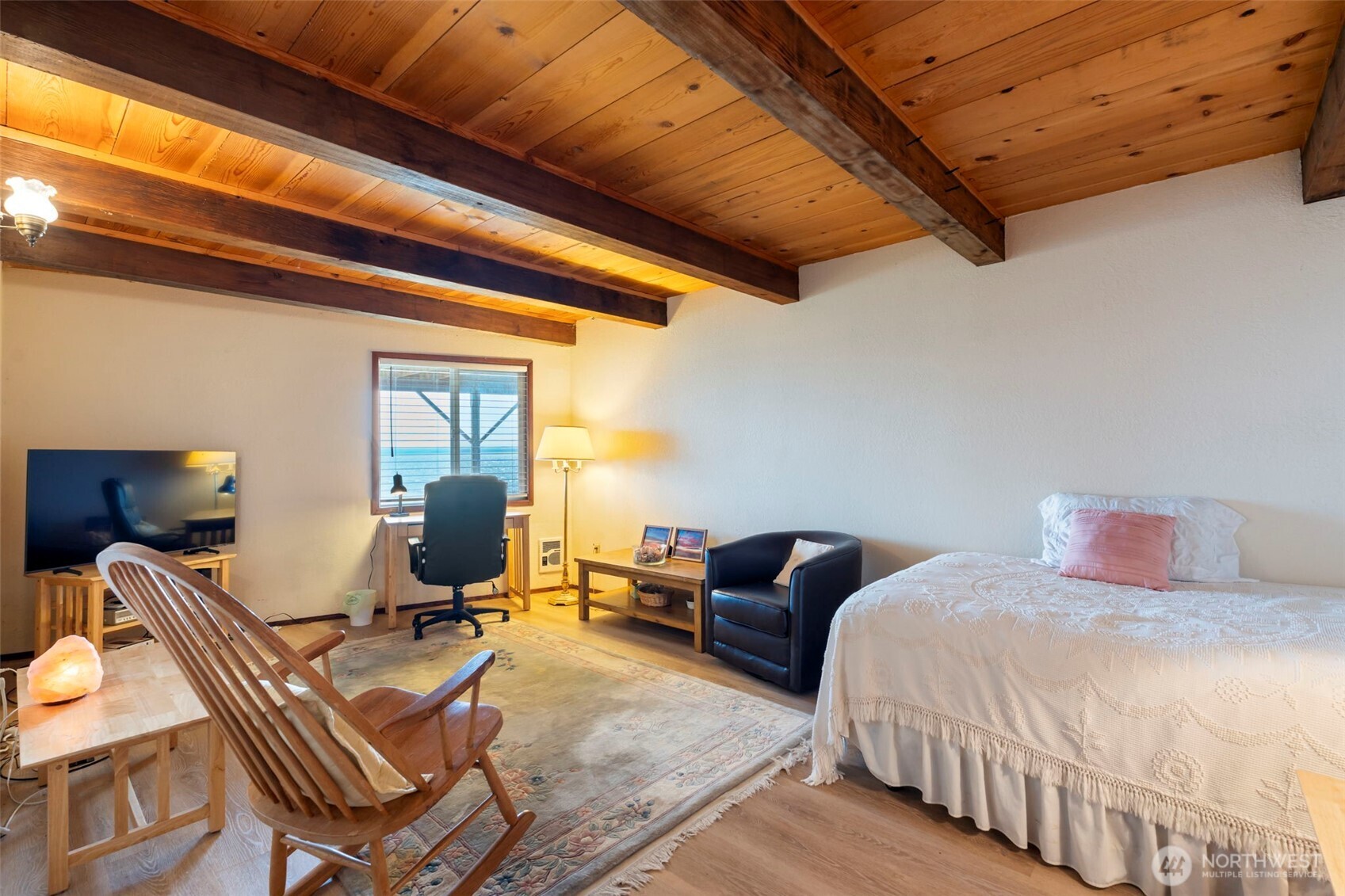 326 Harbor View Loop Southeast Ocean Shores, WA 98569 - Photo 20 of 38 a bedroom with a bed and wooden floor