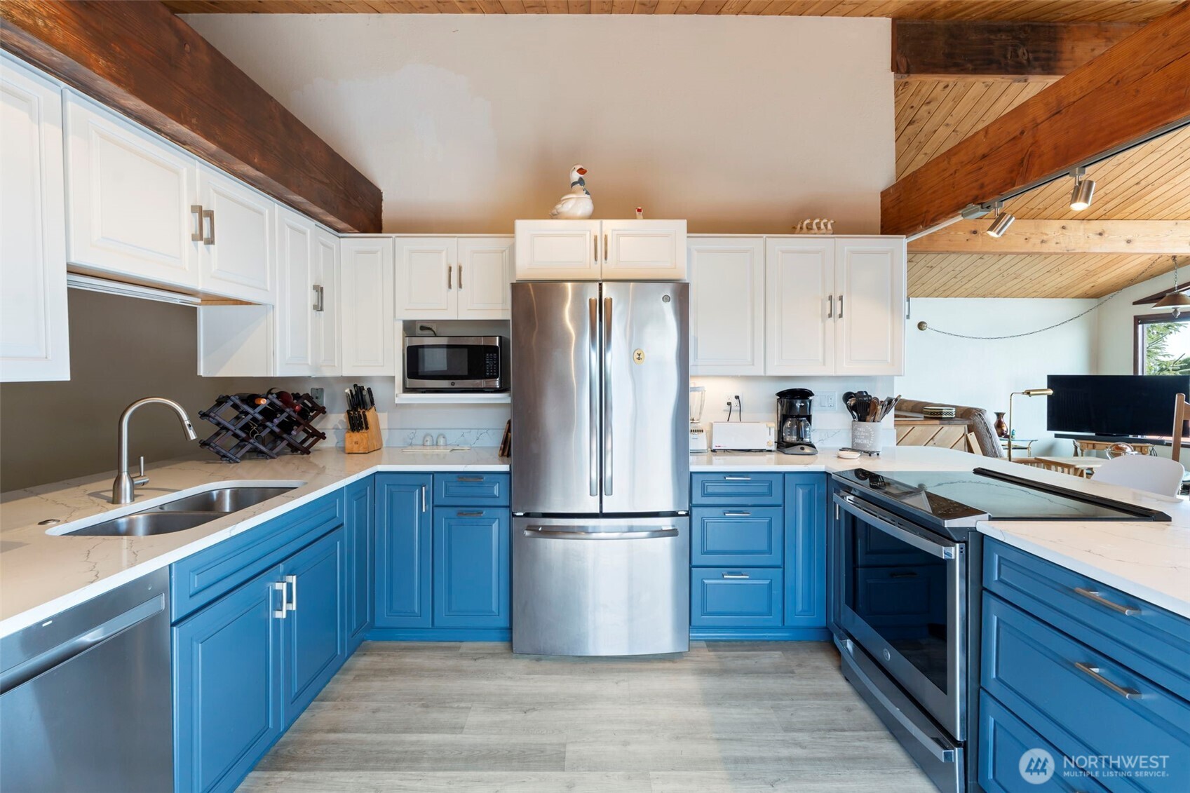 326 Harbor View Loop Southeast Ocean Shores, WA 98569 - Photo 2 of 38 a kitchen with stainless steel appliances granite countertop a refrigerator stove a sink dishwasher and wooden cabinets with wooden floor