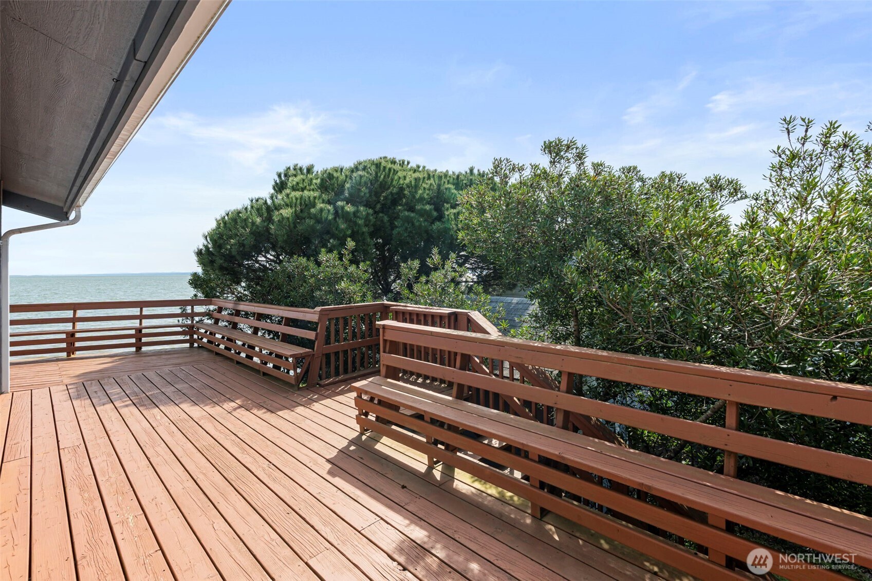 326 Harbor View Loop Southeast Ocean Shores, WA 98569 - Photo 25 of 38 a view of a roof deck with wooden floor and fence with a bench