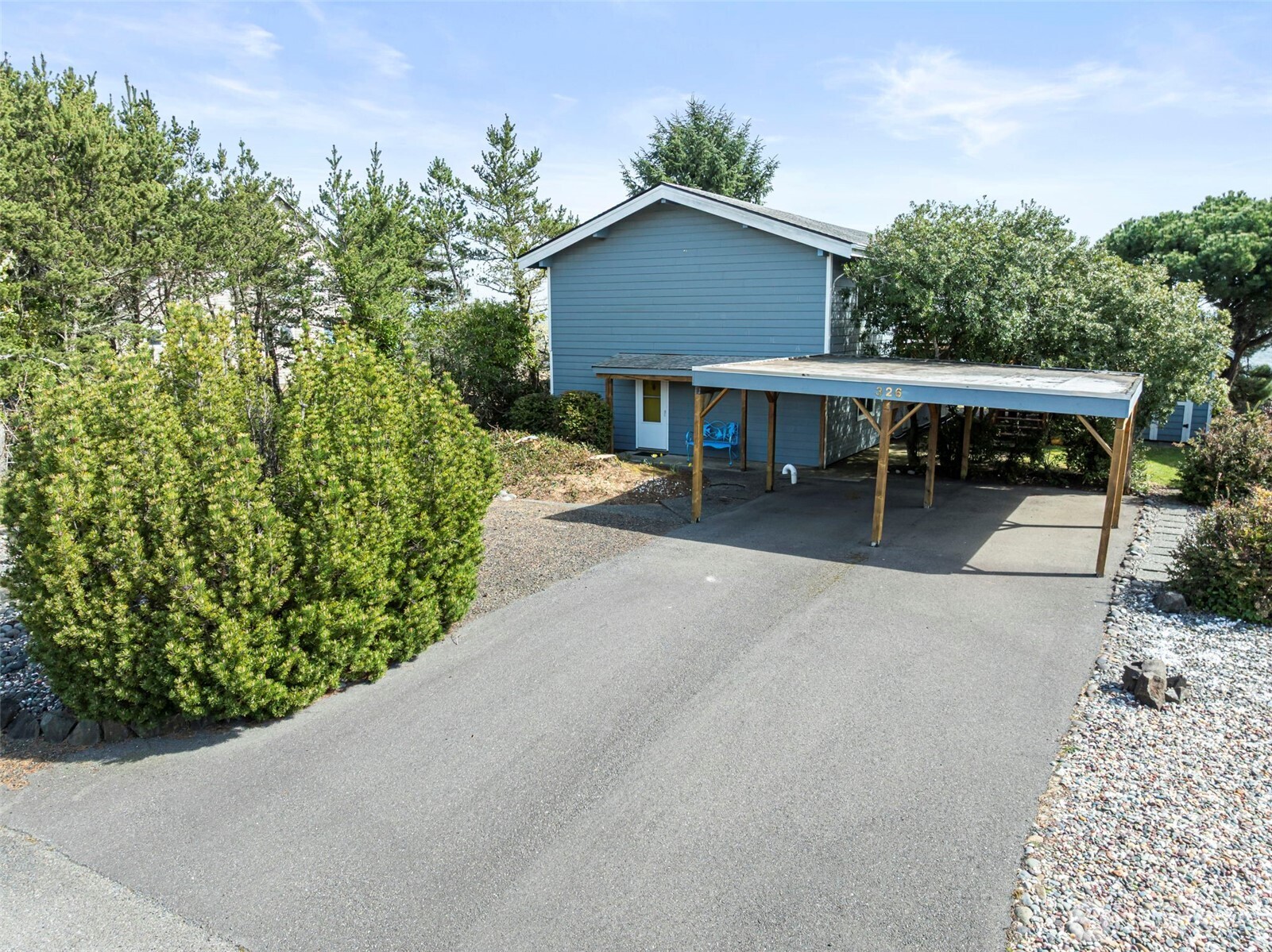 326 Harbor View Loop Southeast Ocean Shores, WA 98569 - Photo 36 of 38 a view of a house with a yard and potted plants