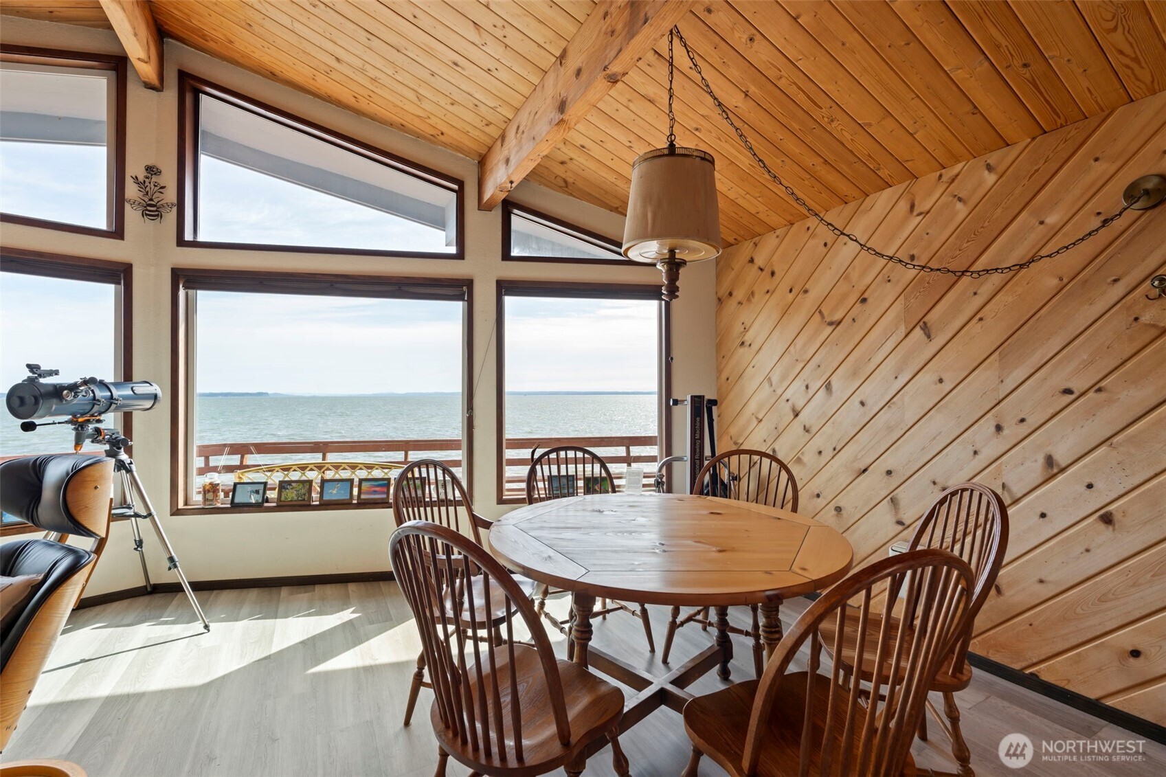 326 Harbor View Loop Southeast Ocean Shores, WA 98569 - Photo 10 of 38 a dining room with furniture and a floor to ceiling window