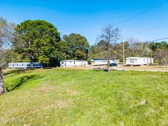 a view of a park with large trees