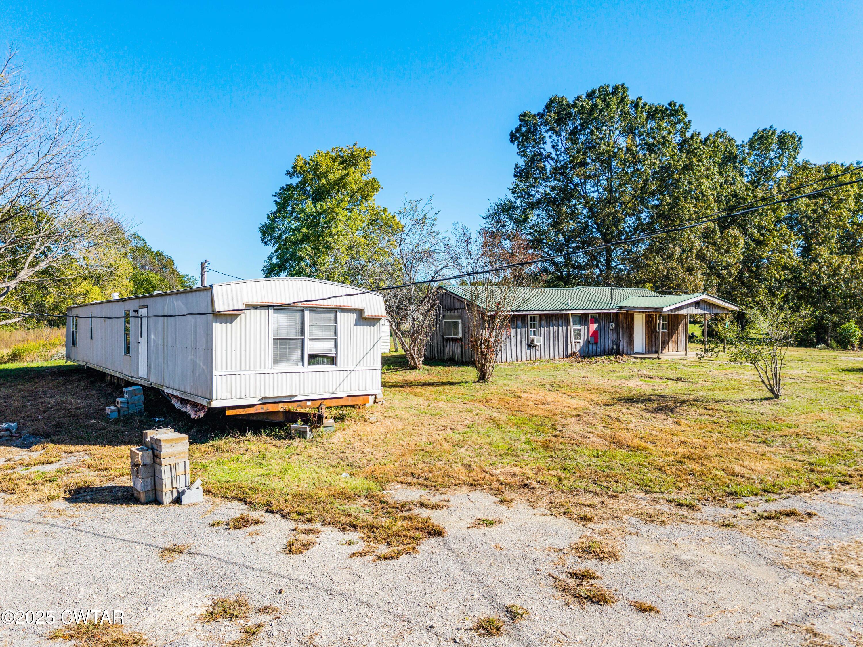0 Charles Lane Cedar Grove, TN 38321 - Photo 14 of 16 a front view of a house with a yard with a large tree