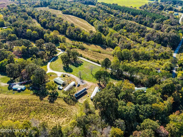 an aerial view of residential house with outdoor space and swimming pool