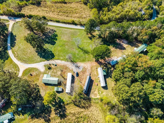 an aerial view of residential house with pool and yard