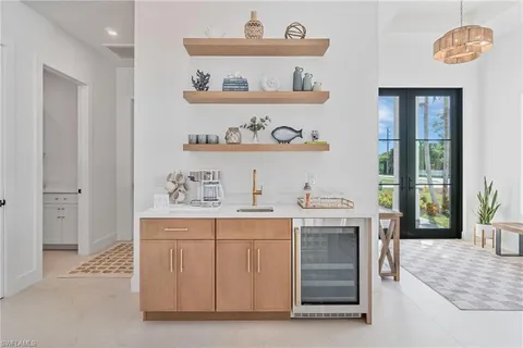 a view of cabinets a sink and a stove in a kitchen