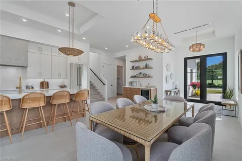 a dining room with furniture a chandelier and window