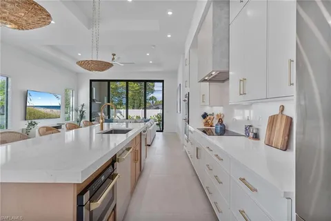a large kitchen with stainless steel appliances lots of counter space and wooden floor
