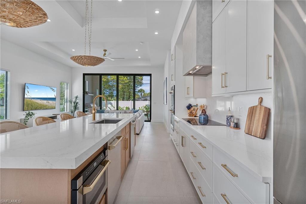 803 96th Avenue North Naples, FL 34108 - Photo 18 of 50 a large kitchen with stainless steel appliances lots of counter space and wooden floor