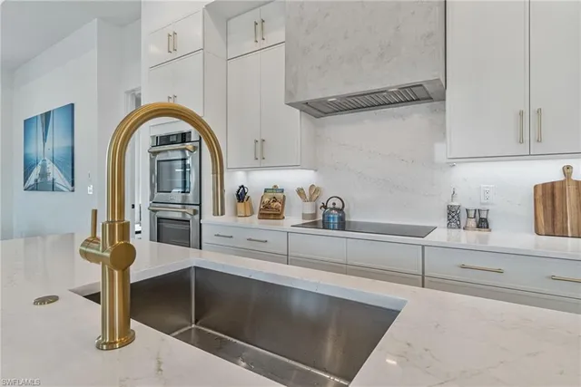 a bathroom with a granite countertop sink mirror vanity and toilet