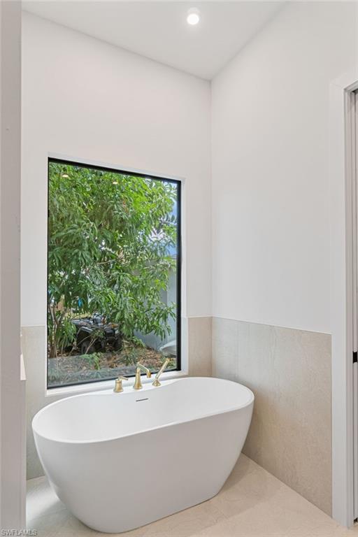 803 96th Avenue North Naples, FL 34108 - Photo 28 of 50 a white bath tub sitting in a bathroom