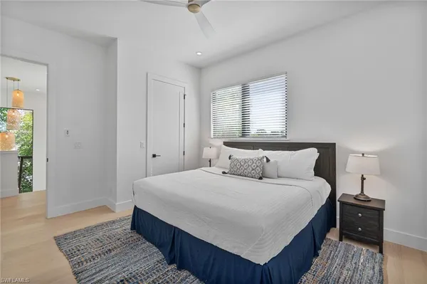 a bedroom with a large bed and a chandelier