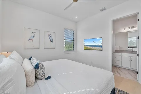 a bathroom with a granite countertop toilet sink and mirror