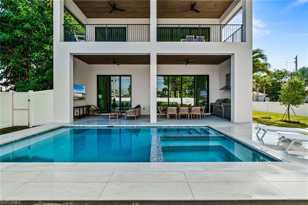 803 96th Avenue North Naples, FL 34108 - Photo 3 of 50 a view of a house with a swimming pool