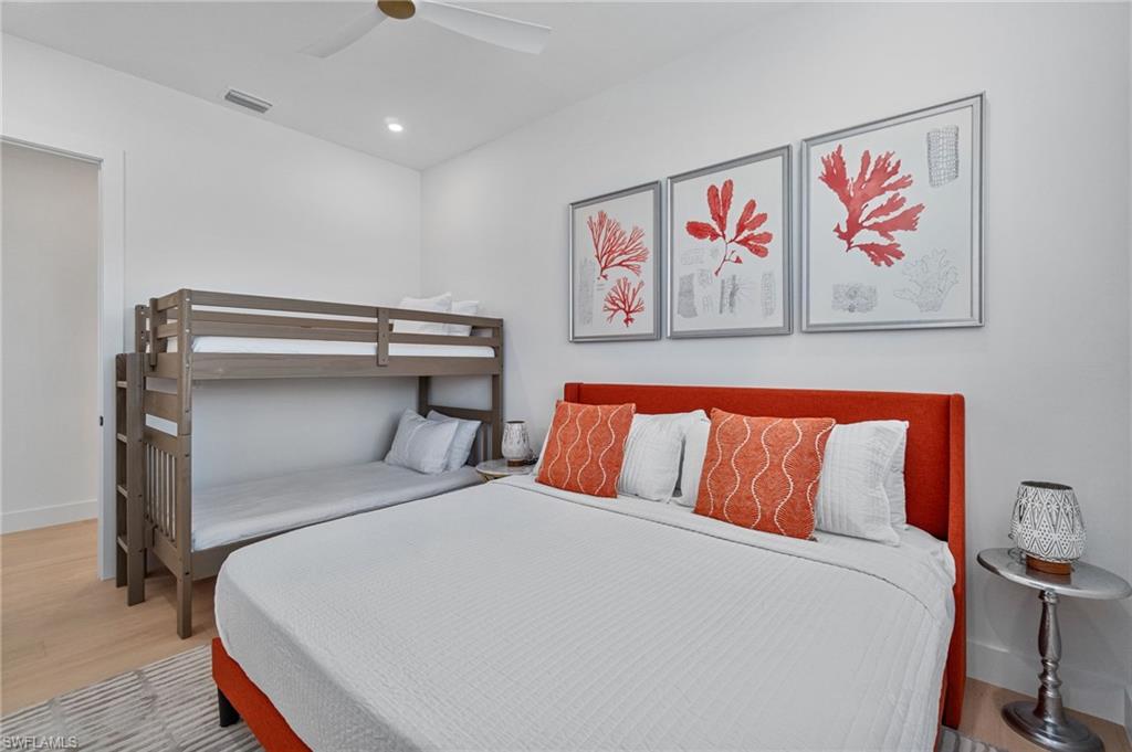 803 96th Avenue North Naples, FL 34108 - Photo 32 of 50 a bed room with a bed and a painting on the wall