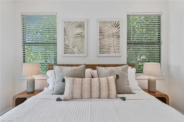 a bedroom with a large bed and a large window