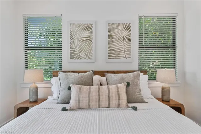 a bedroom with a large bed and a large window