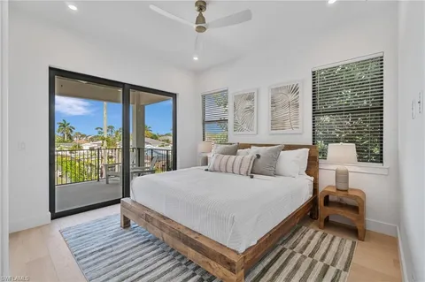 a bedroom with furniture and a ceiling fan
